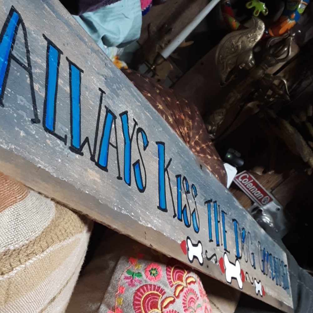 Hand made sign "Always kiss the dog goodnight"